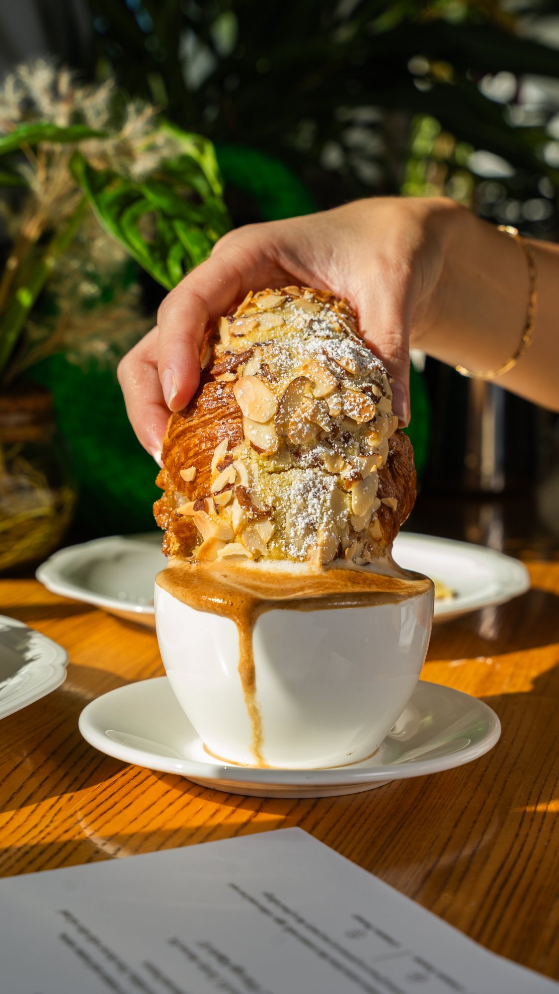Almond croissant dipped in coffee